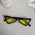 Close-up of triangle cat-eye sunglasses with black frame and yellow translucent lenses - Black Yellow