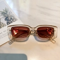 Retro rectangular sunglasses with brown frames and red lenses featuring a gold V detail - Champagne