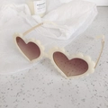 Detailed macro of cream heart sunglasses with petal edge frame and gold metal temples - Pixel Black Grey