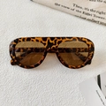 Vista superior de gafas de sol de leopardo vintage con lentes marrones sobre mármol - Montura Carey Lente Té