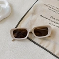 Detail of square sunglasses with cream glossy frames and metallic V accent on the bridge - Off-white