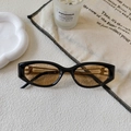 Detail of retro cat-eye sunglasses featuring golden B logo on black temples - Black Frame / Brown Lens (B Logo)