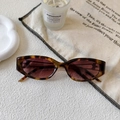 Detail of vintage leopard cat-eye sunglasses with tea lenses on a lifestyle backdrop - Leopard Frame / Tea Lens