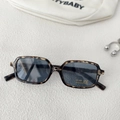 Close-up of tortoise shell square kids sunglasses with UV400 protective lens detail - Mixed Tortoise Gray Lens