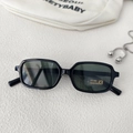 Detail of black rectangular kids sunglasses with UV400 CE label on stone background - Black Frame Green Lens