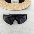 Overhead view of black oversized sports cycling sunglasses on a white textured rug - Dark Grey