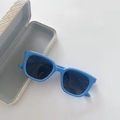 Close-up of blue square kids sunglasses with pointed frame and woven texture case - Blue