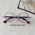 Detailed view of asymmetric kids' rainbow glasses with heart and round frames weighing 20g - Green Pink Black Patterned Legs