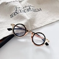 Detail view of steampunk round metal glasses frame with rose gold and black finish - Gold White