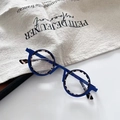 Macro detail of blue round steampunk glasses with tortoise pattern and slim temples - Blue & White
