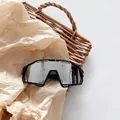 Detail view of large frame kids sports goggles with white splatter pattern on black frame - Black Frame Silver Mirror