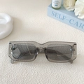 Detail of transparent grey rectangular sunglasses on an elegant textured background - Smoke Gray