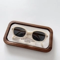 Close-up of cream children's folding sunglasses in a wooden tray with linen texture - Off White