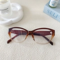 Detailed view of cat-eye frames with clear specifications printed on the temple arm - Gradient Tea To Clear