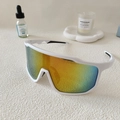 Close-up of white sports sunglasses with rainbow gradient lens on a textured surface - White Frame Red Mirrored Lens