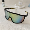 Detail view of large frame cycling sunglasses with multi-color polarized lenses on textured surface - Black Frame Gold Mirror Lens