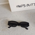 Retro black oval frame kids sunglasses with silver metal accents on stone texture - Black