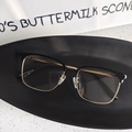 Detail view of half-rim glasses with black and gold metal frames and size engraving - Black Gold Clear Lens