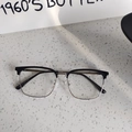 Detail view of classic black browline glasses frames with metal bridge on stone surface - Black Silver Clear Lens