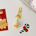 Detail eines gelben Weihnachtsbaum Schlüsselanhängers mit gepunkteter Schleife - Gelber Weihnachtsbaum