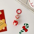 Detail view of Santa Claus and apple charms on a red Christmas keychain with festive cards - Little Apple Charm