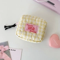 Detail of yellow checkered quilted pouch with heart stitching and tassel zipper - Yellow
