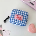 Detail of blue plaid quilted makeup bag with heart stitching and pink woven label - Blue
