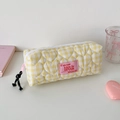 Detailed view of yellow checkered quilted pouch with heart stitching and woven zipper pull - Yellow