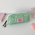 Close-up of green checkered pencil case with heart quilting and pink zipper pull - Green