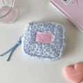 Macro view of blue leopard plush makeup bag with pink woven label and soft texture - Blue