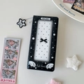 Close-up of black photo album featuring star patterns and transparent cover window - Black