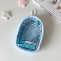 Macro detail of blue plush doll storage bag with transparent PVC window and star moon print - Blue