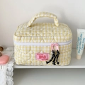 Close-up of heart-shaped quilting and yellow gingham pattern on a large makeup bag - Yellow