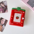 Close-up of strawberry themed photocard binder with snap button and PVC glossy texture - Red