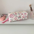 Detailed close-up of quilted floral pencil case with soft padding and pink knot zipper pull - White Flower