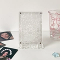 Detail view of transparent acrylic photo frame with ripple texture and magnetic metal studs - Single Slot Stand