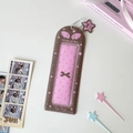 Macro detail of brown Wings of Love photocard holder with pink dots and star pendant - Brown