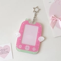 Detail of pink acrylic photo card holder with white wings and star-shaped metal clasp - Rose Red