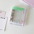 Detail of mini PVC binder with strawberry prints, metal rings and pink snap buttons - Cartoon Strawberry