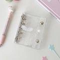 Close-up of a mini 3-ring transparent PVC binder notebook with white wing patterns - White Wings Shell