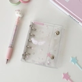Macro shot of a mini 3-ring PVC binder with pink star wing stickers and matching gel pen - Pink Wings Shell
