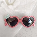 Pink heart-shaped kids sunglasses with cute blue bow accent and dark lenses - Bowknot Rose Pink