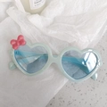Cute mint green heart-shaped kids sunglasses with a pink bow and blue tinted lenses - Bow Blue
