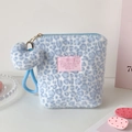 Detail of plush leopard print makeup bag with heart charm and soft faux fur texture - Blue