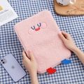 Detail of pink teddy fleece tablet sleeve with cute cartoon embroidery and small 3D legs - Pink