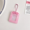 Detailed view of pink acrylic photo card holder with ribbon bow and metal chain - Pink
