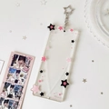 Detail of transparent acrylic card holder with pink stars and star-shaped silver keychain - Black and Pink Stars