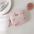 Close-up of pink checkered pouch with red bow print and smooth zip closure detail - Pink Plaid