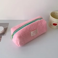 Dettaglio dell'astuccio in peluche rosa con cerniera verde menta e patch del logo - Rosa