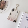 Détail du porte-carte porte-clés en acrylique transparent avec paillettes et étoiles - Noir